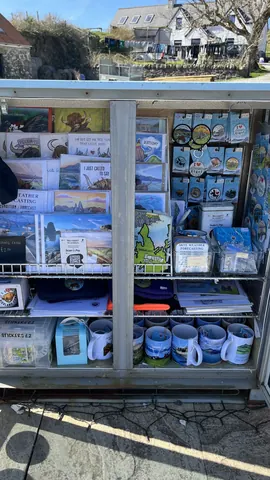 A display of various items, including a book, a mug, and a card.