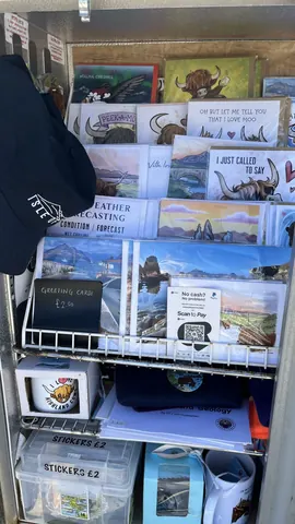 A display of cards and posters with a hat on top.