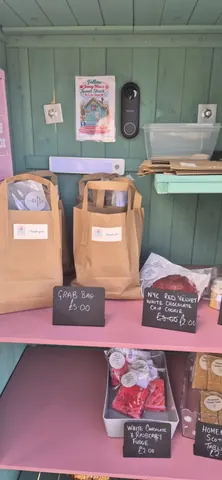 A table with bags of food on it.