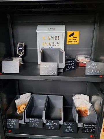A cash register is sitting on a shelf with a sign that says "cash only".