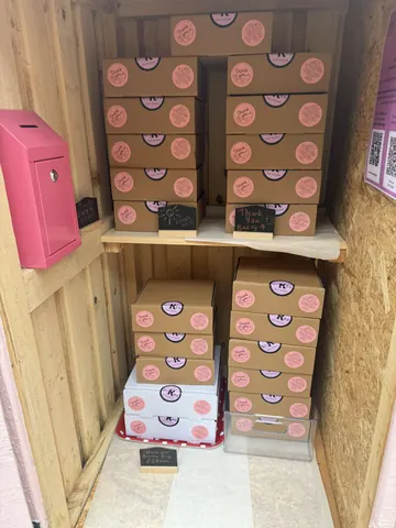 A pink box with a black handle.