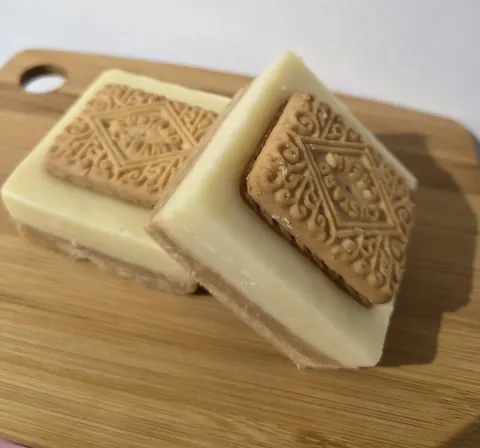 Two pieces of cake on a wooden board.