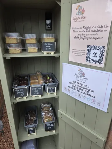 A display case with a sign that says "Cake sale".