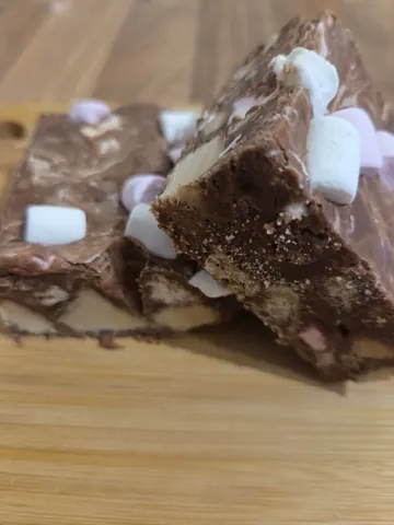 A piece of cake with marshmallows on top.