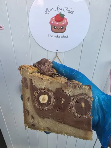 A person is holding a piece of cake.