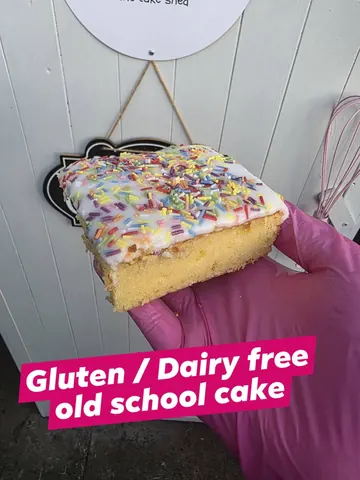 A person is holding a piece of cake.