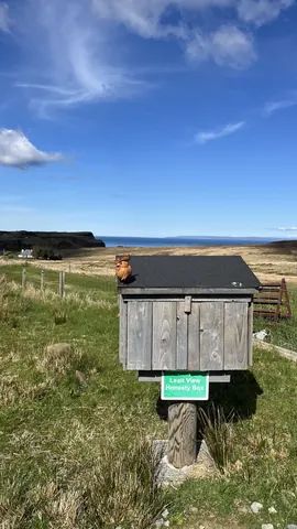 A wooden box with a sign on it that says "Leave a Vine".