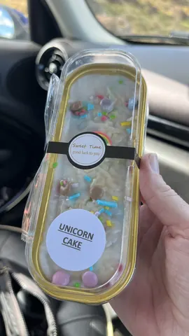 A person is holding a box of cake.