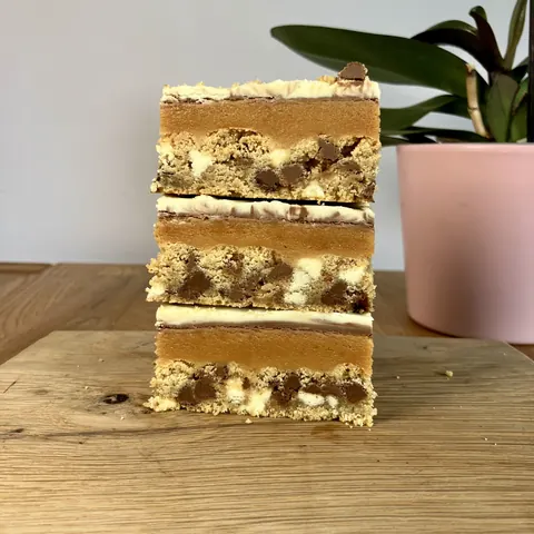 A cake with three layers is sitting on a table.