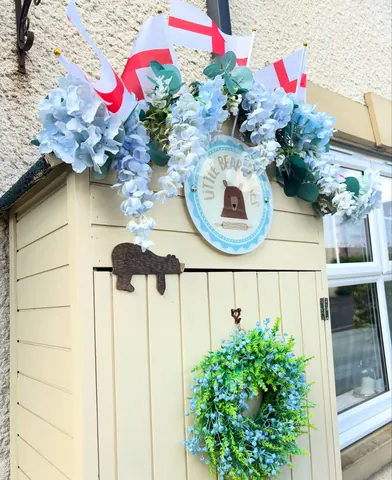 A white door with a blue wreath on it.