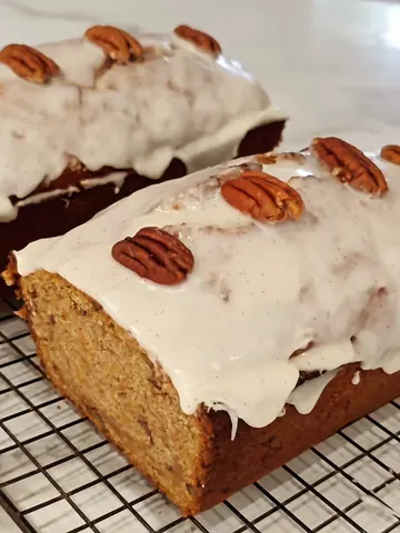 A loaf of bread with nuts on top.
