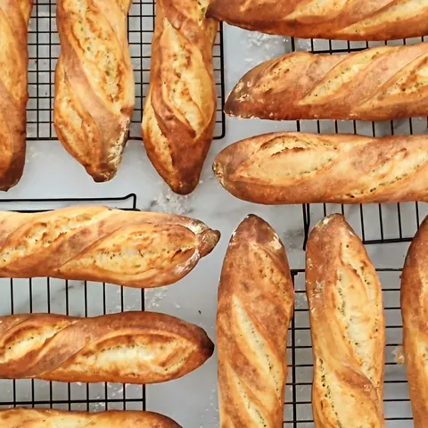 A bunch of bread on a wire rack.