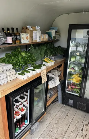 A refrigerator with a sign on the door that says "farm fresh eggs."