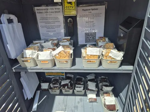 A table with a sign that says Welcome to Little Wen Bake Shop.