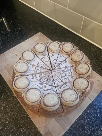 A cake with a clock design on it.