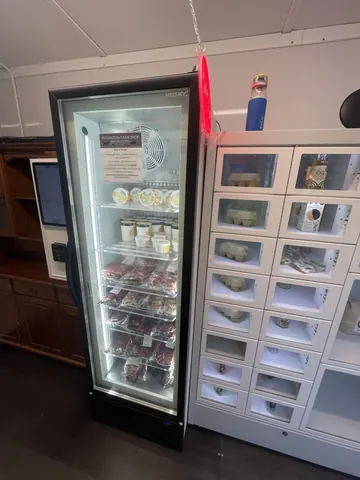 A refrigerator with a red light on it.