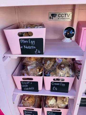 A pink shelf with a sign that says "mini egg & nutella" on it.