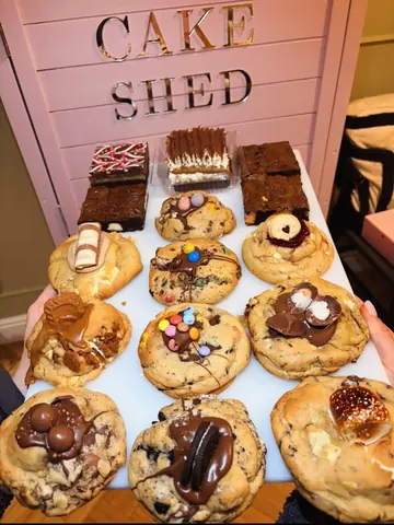 A white plate with a variety of cookies on it.