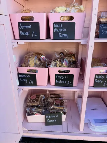 A pink shelf with a sign that says "Jammie Dodger".