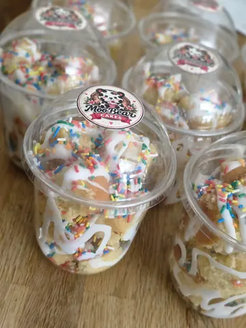 A table with a bunch of cupcakes on it.