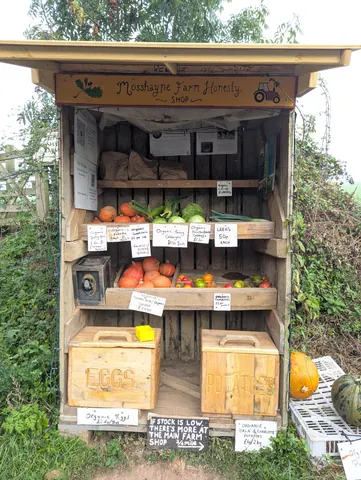 A wooden box with a sign that says Mosshay Farm Honestly.