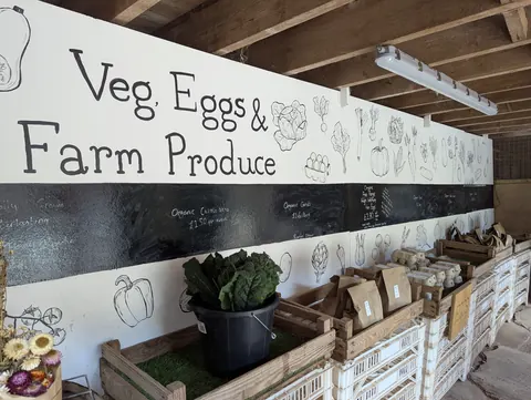 A sign that says Veg, Eggs & Farm Produce.