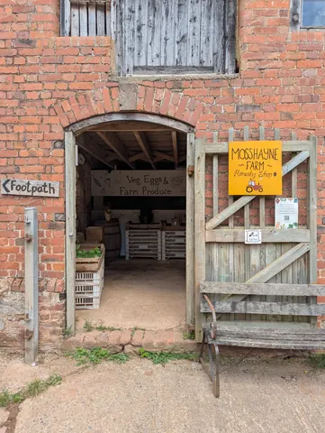 A brick building with a sign that says Mosshane Farm.