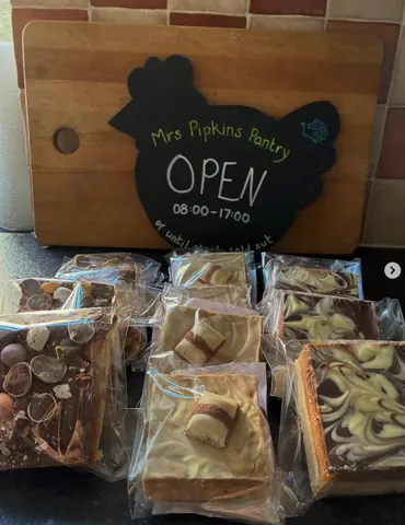 A sign that says Mrs Pipkins Pantry Open.