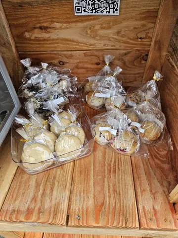A wooden box with a bunch of bags of cookies.