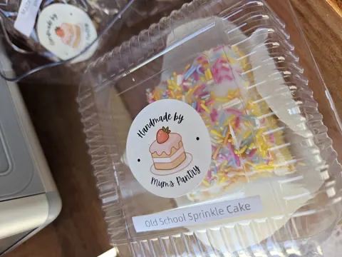 A box of cake with a sticker on it.