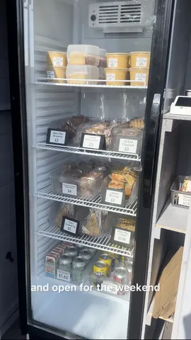 A black refrigerator with a white shelf inside.