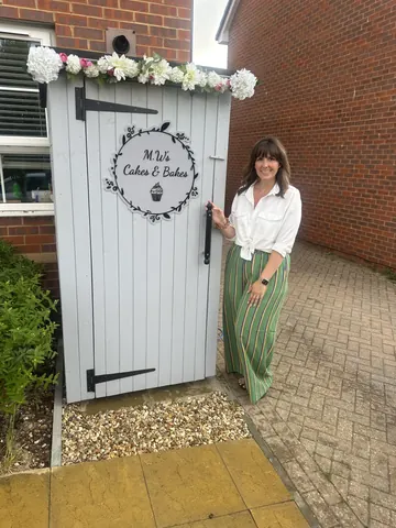 A woman standing in front of a door.