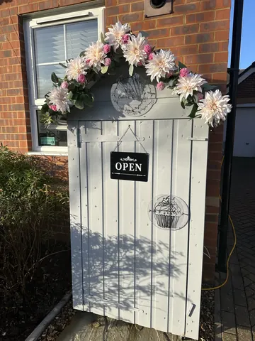 A white door with a sign that says "open" on it.