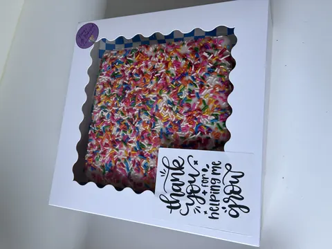 A cake with sprinkles in a box.