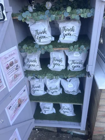 A display of bags with the word "thank" written on them.