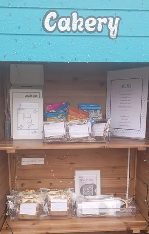 A wooden shelf with a menu on it.