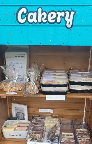 A wooden shelf with a sign that says "welcome to our crafts table".