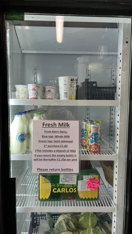 A refrigerator with milk and other items inside.