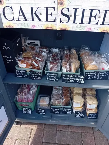 A display case with a sign that says "Cake Shed" on it.