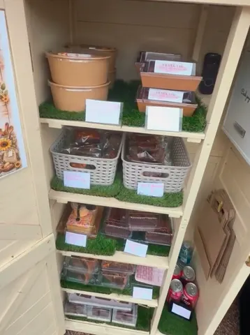 A shelf with a variety of food items and drinks on it.