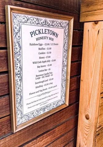 A menu board with a price list of food items.
