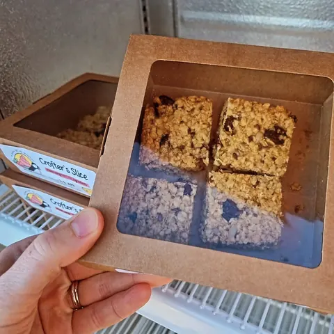 A box of cereal bars is being held by a person.