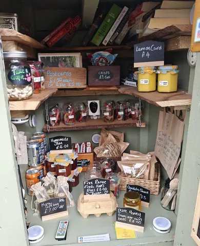 A small room with a shelf full of food and drinks.
