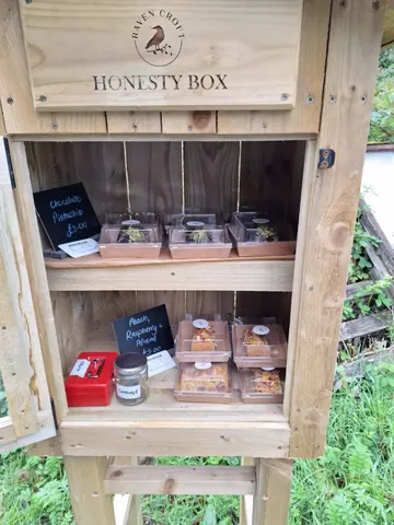 A wooden box with a sign that says Honesty Box.