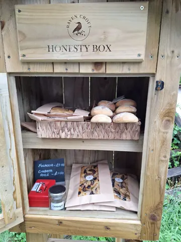 A wooden box with a sign that says Honesty Box.