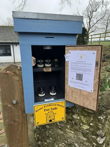 A blue box with a yellow sign on it.