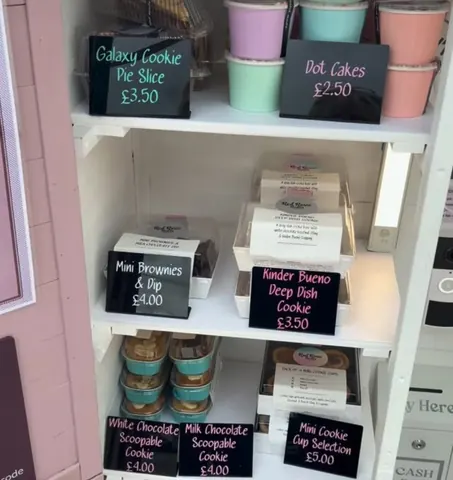 A display case with a variety of cookies and other baked goods.