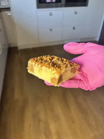 A person is holding a piece of food in their hand.