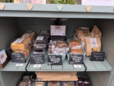 A blue shelf with a variety of food items on it.