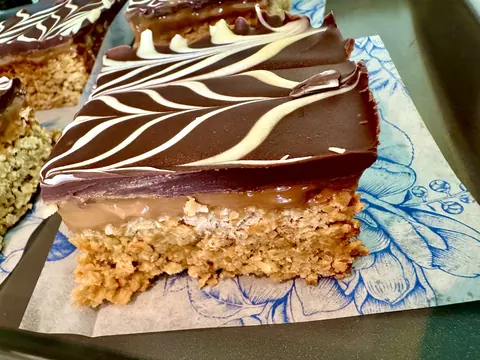A piece of chocolate cake with white stripes on it.